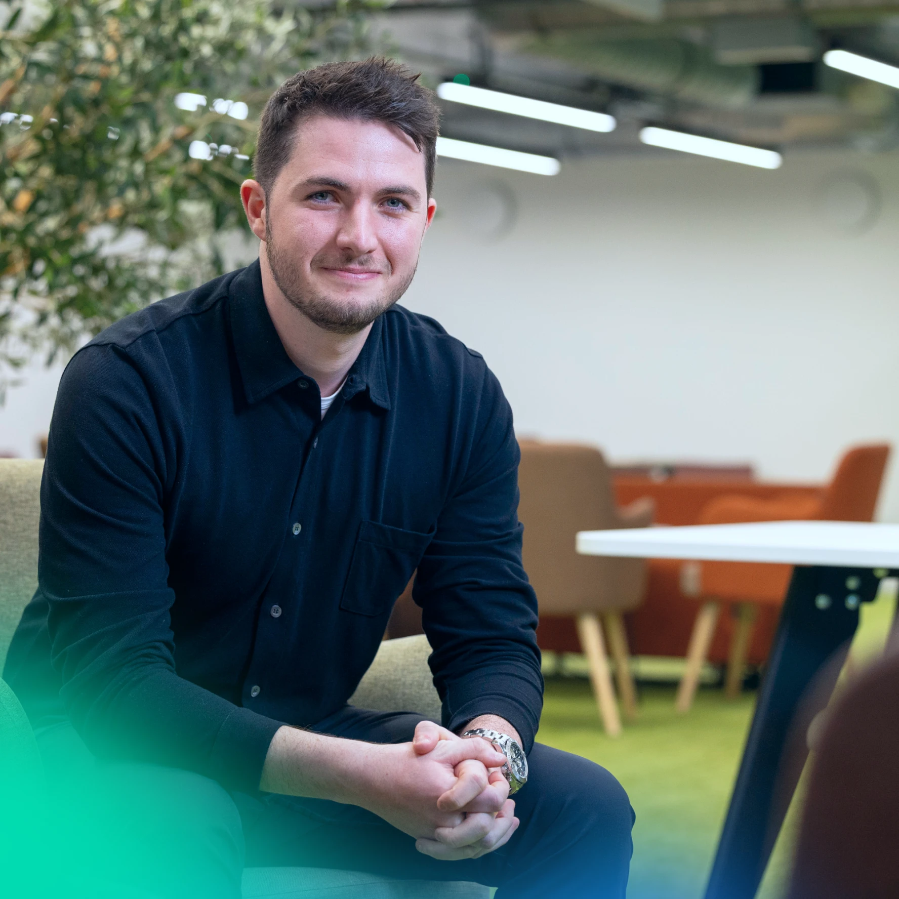 Man smiling at the camera in an office