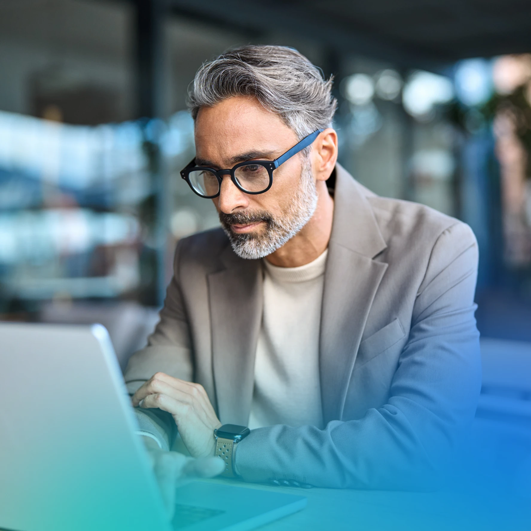 Man on a laptop in a car dealership