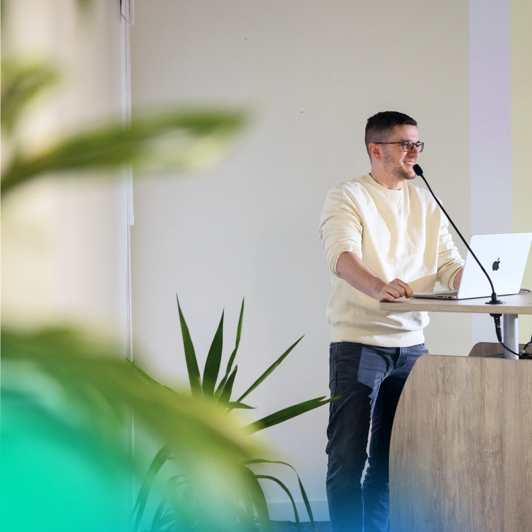 Man speaking at a lectern at an office