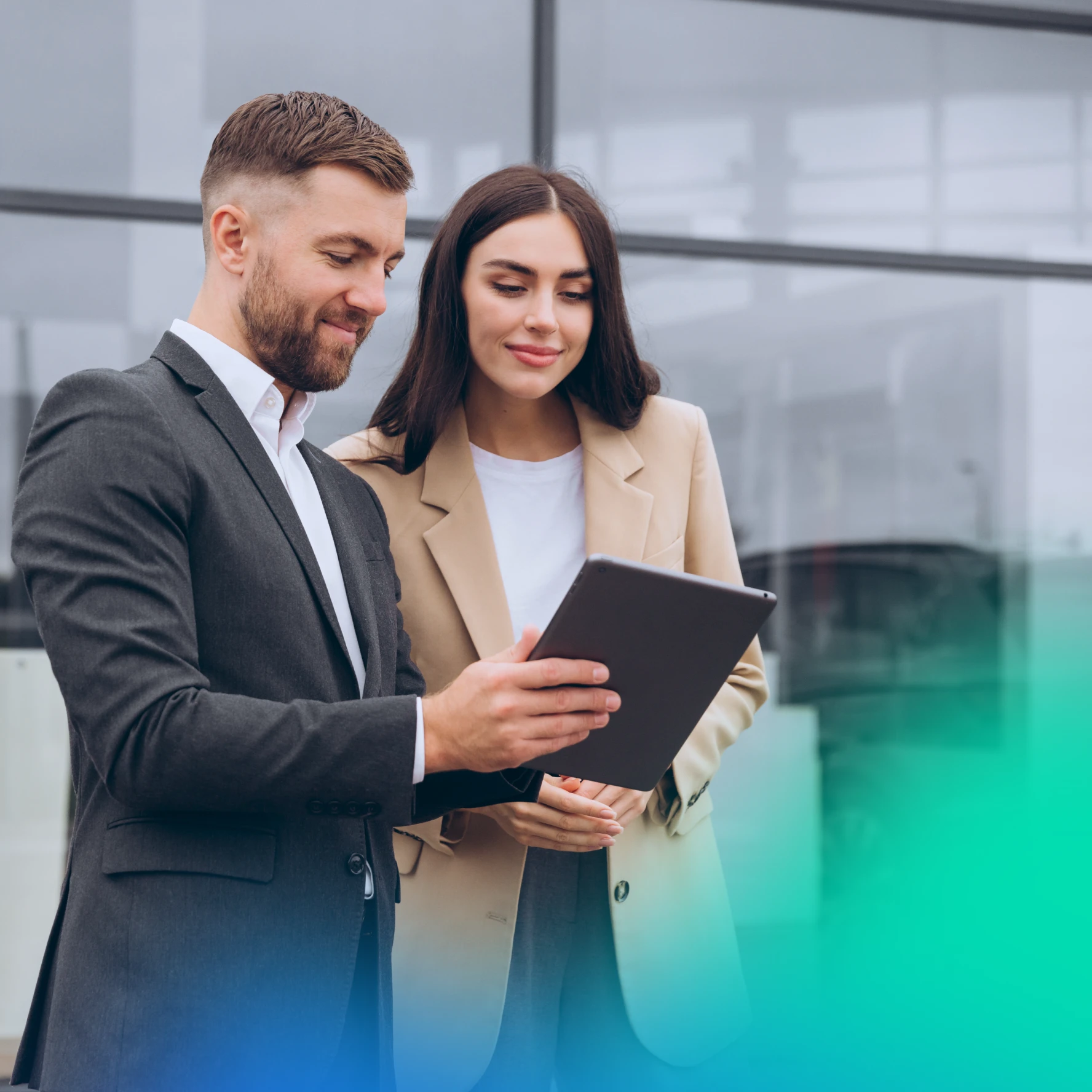 Man and woman looking at a tablet in a car dealership