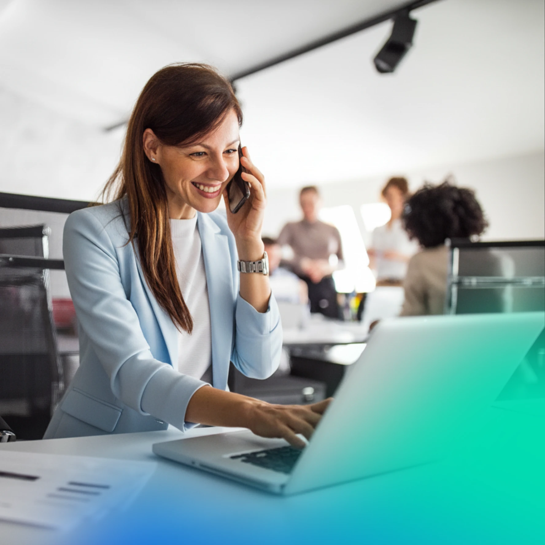Woman on the phone typing into her laptop