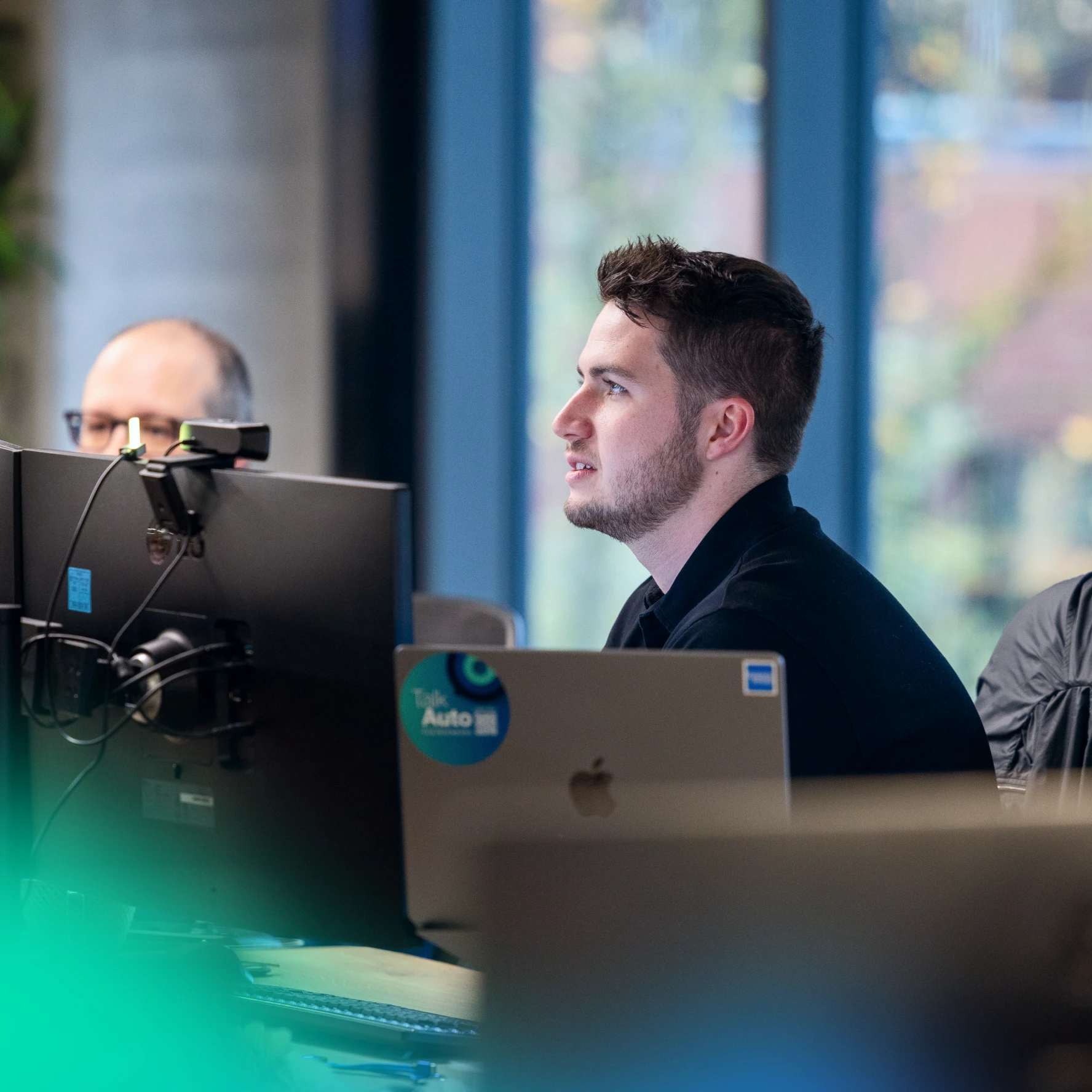 Man talking to team member in an office