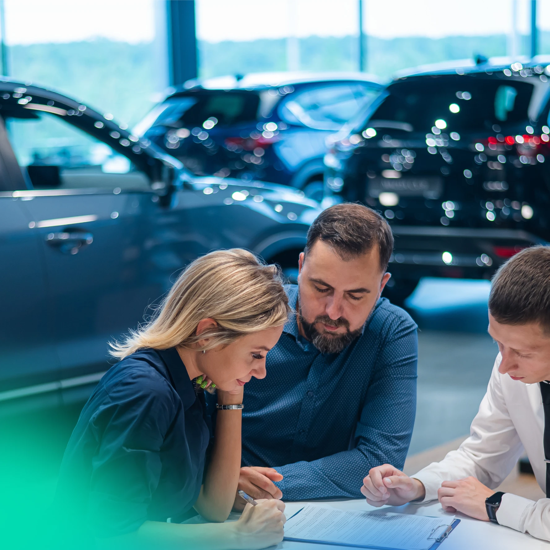 customers signing car finance agreement at car dealership