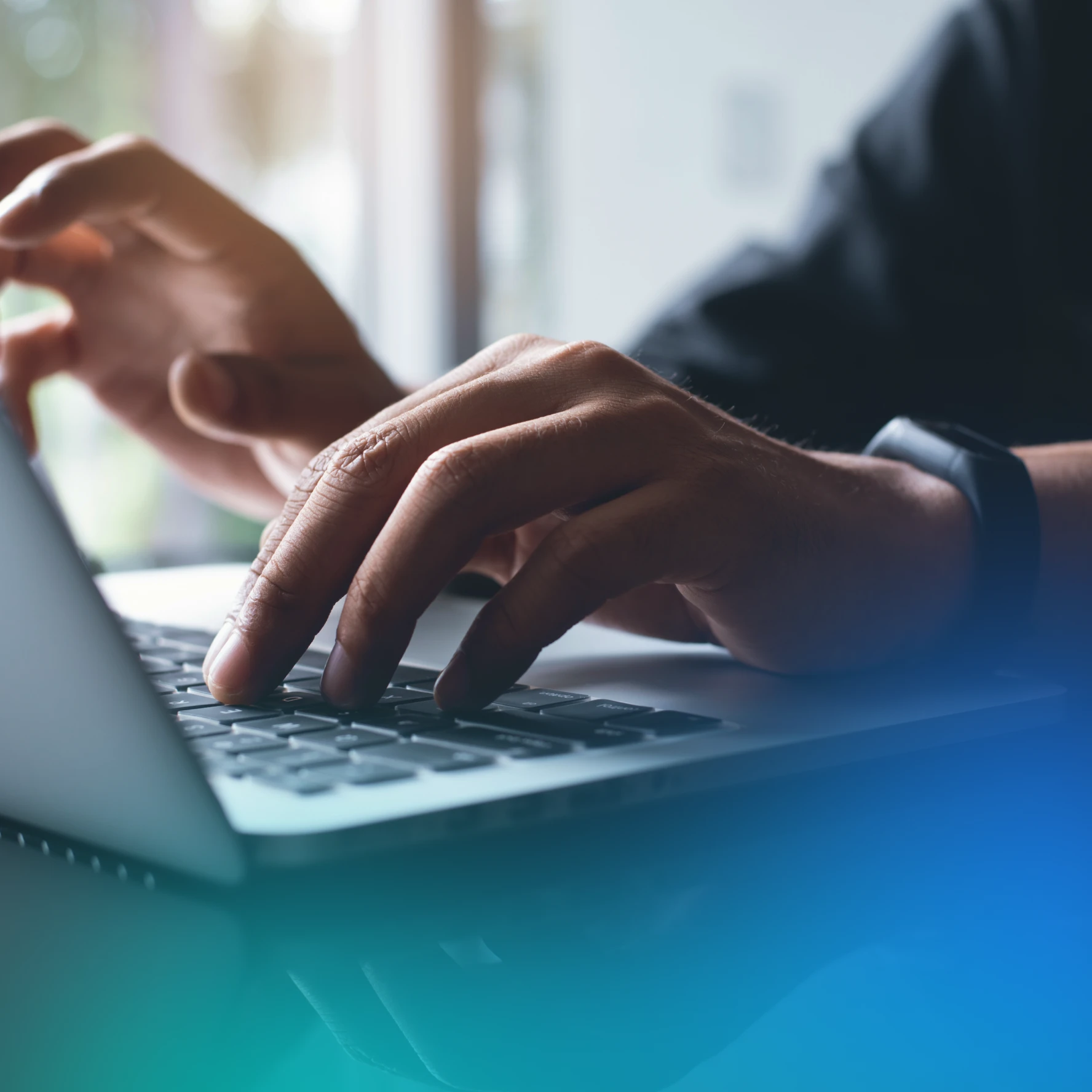 man typing on laptop