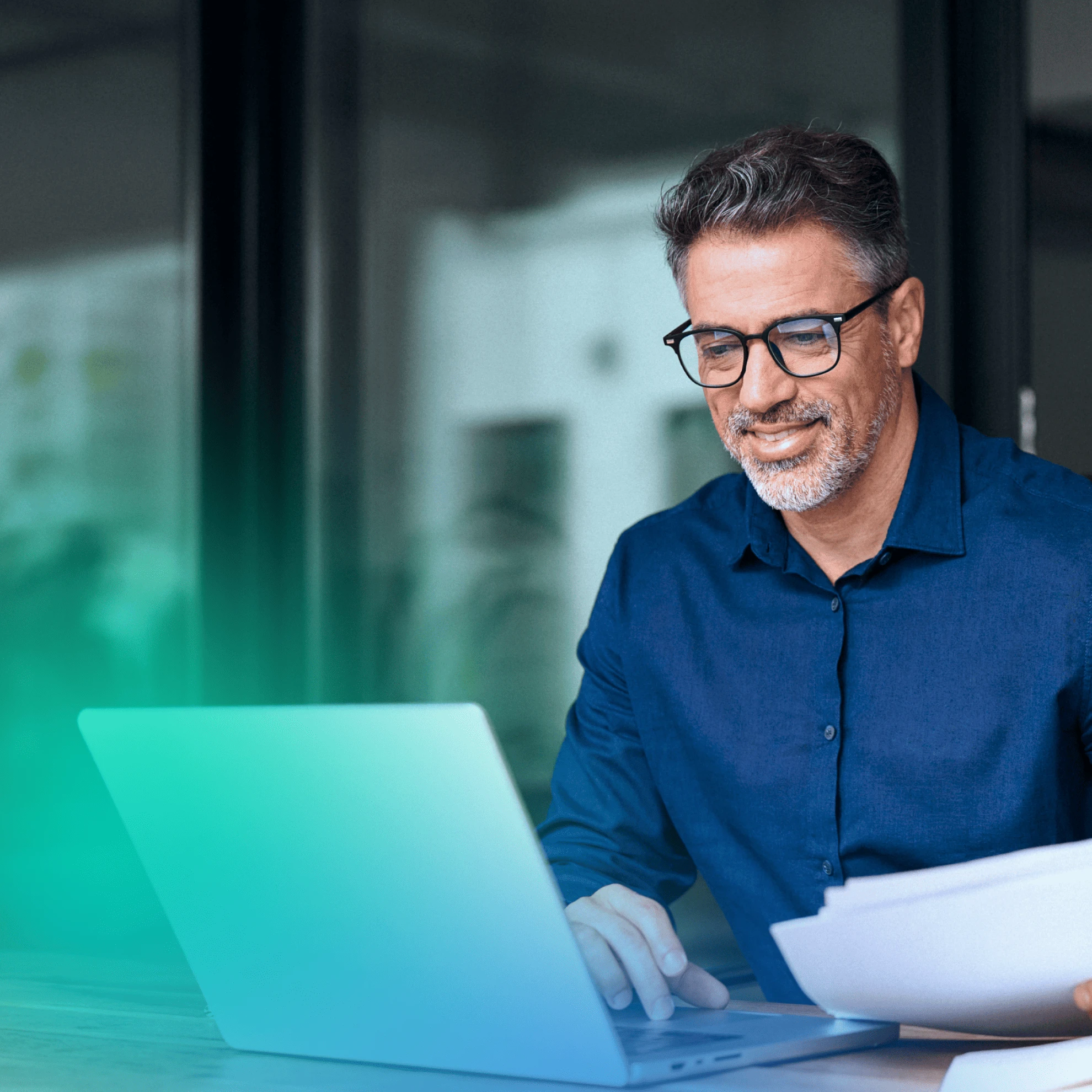 Man at a car dealership on his laptop